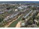 Expansive aerial view showcasing a community with waterfront condos, green spaces and nearby buildings at 19827 Henderson Rd # L, Cornelius, NC 28031