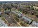 Aerial view showcasing townhomes next to a stream and landscape with bare trees at 19827 Henderson Rd # L, Cornelius, NC 28031