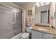 Bathroom featuring a vanity with a granite countertop, a shower with glass doors and neutral decor at 19827 Henderson Rd # L, Cornelius, NC 28031