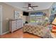 Comfortable bedroom featuring hardwood floors, a ceiling fan, and natural light from a window at 19827 Henderson Rd # L, Cornelius, NC 28031