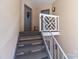 Condo staircase with neutral walls, carpeted stairs, and view of building entrances, creating a cozy arrival at 19827 Henderson Rd # L, Cornelius, NC 28031