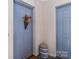Charming condo entryway with vibrant blue doors, decorative flowers and a ceramic accent stool at 19827 Henderson Rd # L, Cornelius, NC 28031