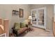 Serene hallway with french doors leading into bedroom, complemented by a bench and accent lamp at 19827 Henderson Rd # L, Cornelius, NC 28031