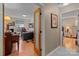 Inviting hallway showcasing a view into the office and another room, with light hardwood flooring at 19827 Henderson Rd # L, Cornelius, NC 28031