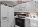 Bright kitchen features white appliances, ample storage and a functional design for easy meal preparation at 19827 Henderson Rd # L, Cornelius, NC 28031