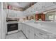 Cozy kitchen featuring white cabinets, ample countertop space, and open layout to adjacent dining area at 19827 Henderson Rd # L, Cornelius, NC 28031