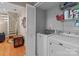 Laundry room with modern appliances, storage shelves, and convenient access to the rest of the house at 19827 Henderson Rd # L, Cornelius, NC 28031