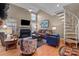 Inviting living room featuring a fireplace, tall ceilings and spiral staircase at 19827 Henderson Rd # L, Cornelius, NC 28031