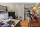 Bright office space with a desk, monitor, and an adjacent room featuring a wood-burning fireplace at 19827 Henderson Rd # L, Cornelius, NC 28031