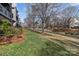 Picturesque waterfront view with lush green grass, mature trees, and neighboring condos, creating a serene environment at 19827 Henderson Rd # L, Cornelius, NC 28031