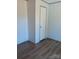 Simple bedroom with wood flooring, neutral walls, and a white interior door at 2013 Vick Wilson Rd, Shelby, NC 28152