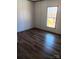Empty bedroom with wood flooring and a bright window view overlooking the yard at 2013 Vick Wilson Rd, Shelby, NC 28152