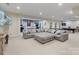 Finished basement with open layout including sitting area, game area, and lounge at 208 Woodwinds Dr, Mount Holly, NC 28120