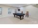 Finished basement features a pool table, dart board, carpet, and natural light at 208 Woodwinds Dr, Mount Holly, NC 28120