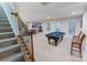 Finished basement featuring a pool table, neutral carpet, and stairs leading to upper level at 208 Woodwinds Dr, Mount Holly, NC 28120