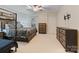 Bedroom featuring neutral colored walls, carpet, a ceiling fan and dark wood furniture at 208 Woodwinds Dr, Mount Holly, NC 28120