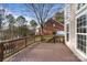 Spacious wooden deck overlooking trees, with wooden railings and room for outdoor furniture at 208 Woodwinds Dr, Mount Holly, NC 28120