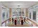 Bright dining room with large windows, modern chandelier, and hardwood floors at 208 Woodwinds Dr, Mount Holly, NC 28120