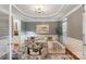 Elegant living room with tray ceiling, stylish decor, and hardwood floors at 208 Woodwinds Dr, Mount Holly, NC 28120