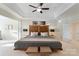 Serene main bedroom with tray ceilings, carpet flooring, and ample natural light at 208 Woodwinds Dr, Mount Holly, NC 28120