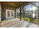 Covered patio with lake view, featuring an open-air design and double doors leading inside at 208 Woodwinds Dr, Mount Holly, NC 28120