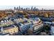 Stunning aerial view of a modern residential neighborhood, with a focus on rooftop terraces and the vibrant city skyline beyond at 231 Uptown West Dr, Charlotte, NC 28208