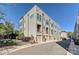 Modern townhome with neutral siding, multiple stories, and individual garage access at 231 Uptown West Dr, Charlotte, NC 28208