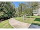 Walking path leading to Gold Park, surrounded by lush greenery and mature trees at 231 Uptown West Dr, Charlotte, NC 28208