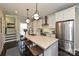 Beautiful kitchen featuring a central island, stainless steel appliances, and modern pendant lighting at 231 Uptown West Dr, Charlotte, NC 28208