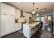 Bright modern kitchen with an island, stainless steel appliances, and dark hardwood floors at 231 Uptown West Dr, Charlotte, NC 28208