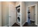 Convenient laundry closet with a stacked washer and dryer unit, adjacent to the open Primary bedroom at 231 Uptown West Dr, Charlotte, NC 28208
