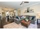Spacious living room featuring a gray sofa, ottoman, hardwood floors, and an open floor plan to the kitchen at 231 Uptown West Dr, Charlotte, NC 28208