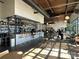 Restaurant featuring a modern bar, ample seating, and natural light from large windows at 231 Uptown West Dr, Charlotte, NC 28208