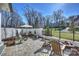 Picturesque backyard with lush lawn, brick patio, and distant view of an elegant home at 2509 Montrose Ct, Charlotte, NC 28207