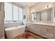 Stylish bathroom with a freestanding tub, double vanity, large mirror, and modern design at 2509 Montrose Ct, Charlotte, NC 28207