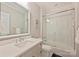 Well-lit bathroom with a large mirror over the sink and glass-enclosed shower/tub at 2509 Montrose Ct, Charlotte, NC 28207