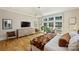 Spacious bedroom featuring hardwood floors, large windows, comfortable seating, and a dresser at 2509 Montrose Ct, Charlotte, NC 28207