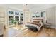 Sunlit bedroom with large windows, hardwood floors, comfortable seating, and a luxurious bed at 2509 Montrose Ct, Charlotte, NC 28207