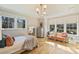 Cozy bedroom with natural light, seating area, and hardwood floors at 2509 Montrose Ct, Charlotte, NC 28207