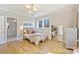 Bright bedroom with hardwood floors, neutral tones, and a view to an ensuite at 2509 Montrose Ct, Charlotte, NC 28207