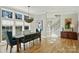 Dining room with large windows, stylish lighting, and access to an adjacent staircase and living spaces at 2509 Montrose Ct, Charlotte, NC 28207