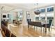 Sunlit dining room with hardwood floors, a stylish chandelier, and views of the outdoors at 2509 Montrose Ct, Charlotte, NC 28207