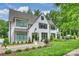 Beautiful white brick home with professionally landscaped yard and black frame windows at 2509 Montrose Ct, Charlotte, NC 28207