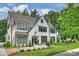 Charming white brick home with black-framed windows and professionally landscaped front yard at 2509 Montrose Ct, Charlotte, NC 28207