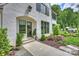 Beautiful home exterior featuring a brick facade, manicured landscaping, and well-lit walkway at 2509 Montrose Ct, Charlotte, NC 28207