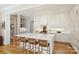 Open-concept kitchen features an expansive island with bar stool seating, white cabinets, and modern lighting at 2509 Montrose Ct, Charlotte, NC 28207