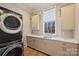 Spacious laundry room with modern washer and dryer, ample counter space, and cabinets at 2509 Montrose Ct, Charlotte, NC 28207