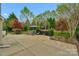 Landscaped backyard featuring a shaded seating area and lush green lawn at 2711 Liberty Hall Ct, Waxhaw, NC 28173