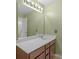 Bathroom featuring a modern vanity with white countertop, large mirror, and updated lighting at 2711 Liberty Hall Ct, Waxhaw, NC 28173