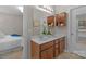 Bathroom featuring double vanity with a large mirror, cherry cabinets, and access to both bedroom and water closet at 2711 Liberty Hall Ct, Waxhaw, NC 28173